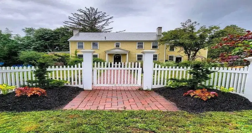 Front yard after landscaping: new mulch beds, plantings and a brick walkway