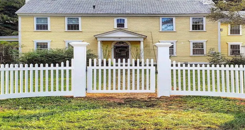Front yard before landscaping: bare patchy grass along the fence